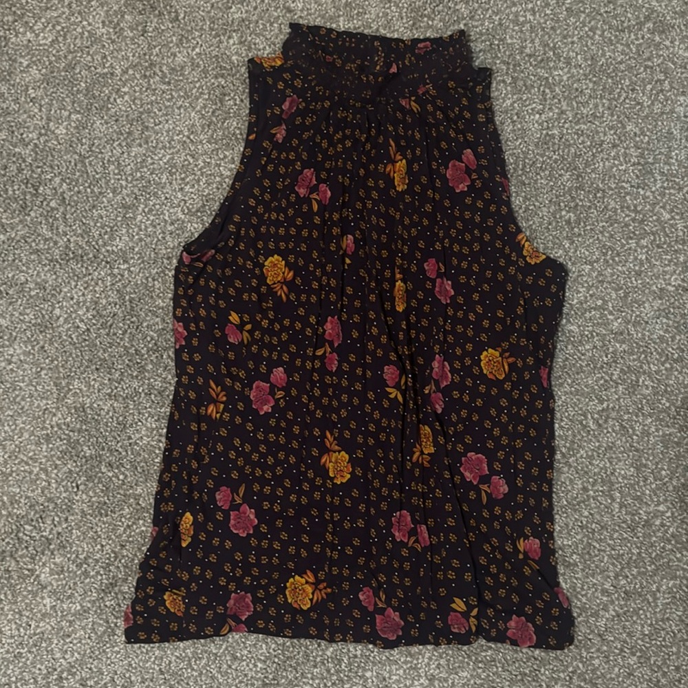 A plum sleeveless blouse with pink and gold florals
